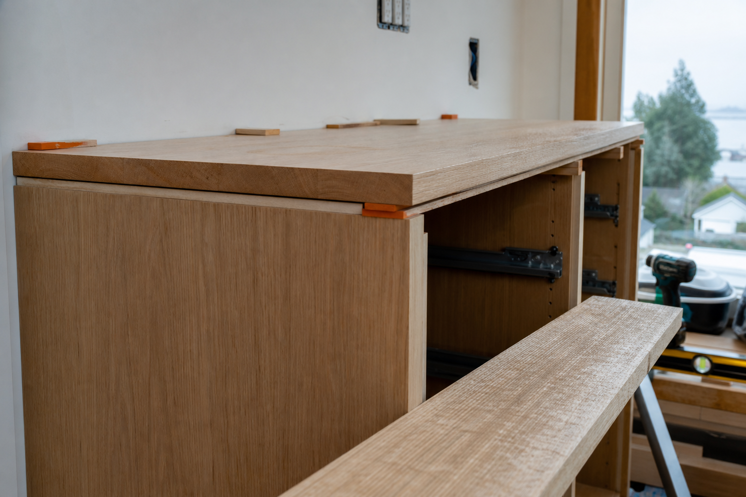 Floor-to-ceiling built-in pantry in a North Vancouver kitchen, Baltic-birch ply carcass with solid-fir face frame, oiled and installed against an out-of-square wall